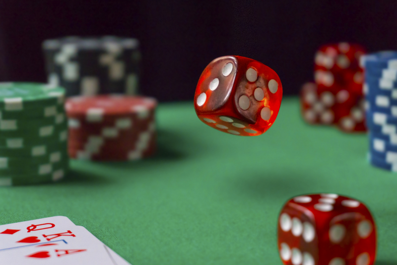 30393154-red-dice-casino-chips-cards-on-green-felt
